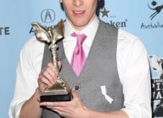 86740 dustin lance black poses with his award for best first screenplay for milk at the 24th annual film i